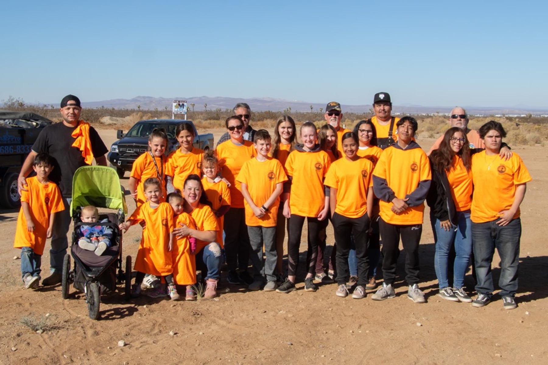High Desert Keepers volunteers posing together in orange organization shirts